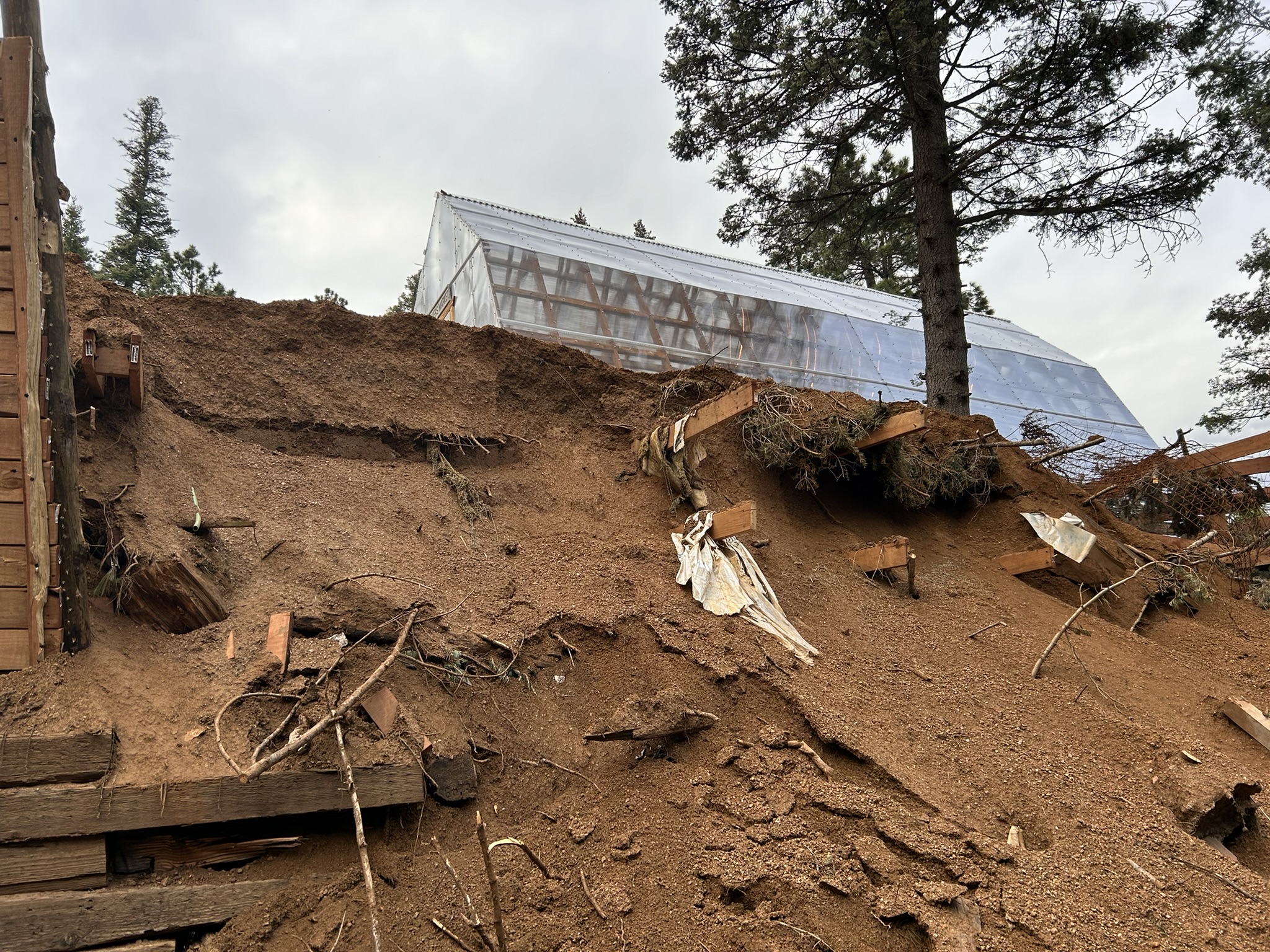 Greenhouse structure rising from the hillside on the ranch.